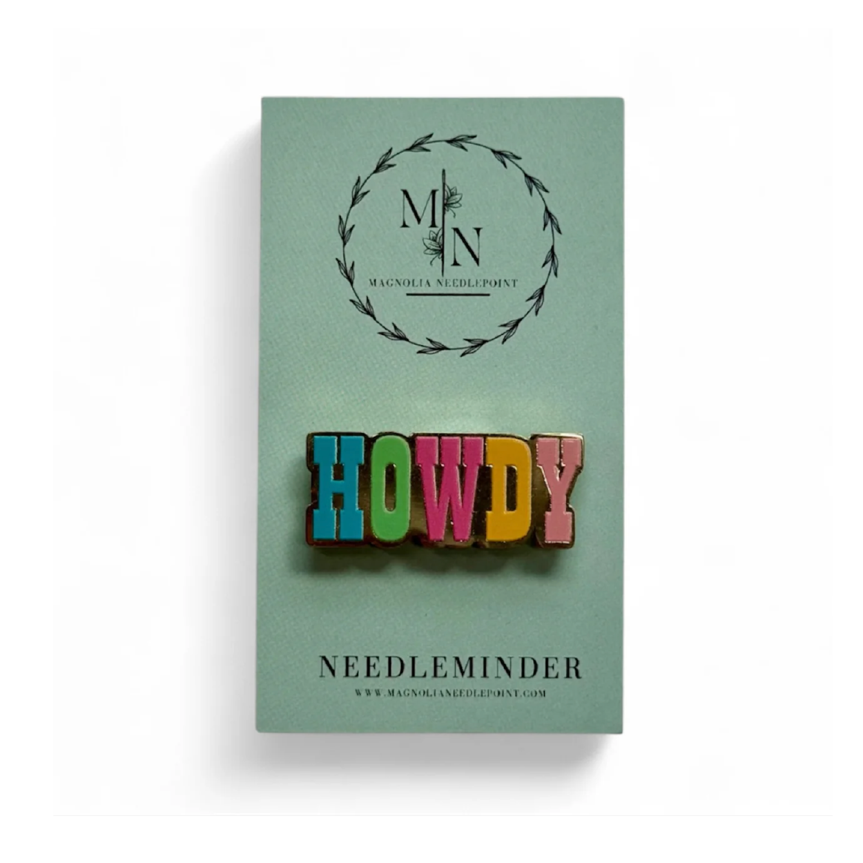 Colorful 'HOWDY' needleminder on a green card with brand logo